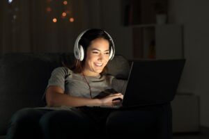 student taking a mental health break with headphones and a laptop