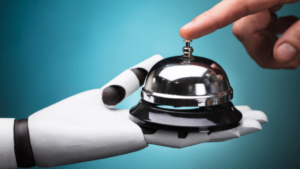 robotic hand offering desktop bell to person who is pressing the bell's button