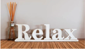 sign saying Relax with aromatherapy reeds in background