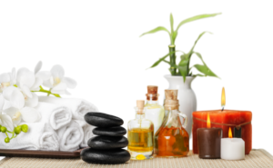spa and wellness setting with aromatherapy oils, smooth stones, towels, and candles
