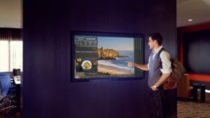 person using virtual concierge screen on wall