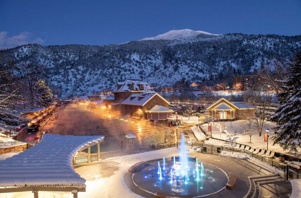 exterior of Glenwood Hot Springs Resort during the evening, with snowy mountain in background