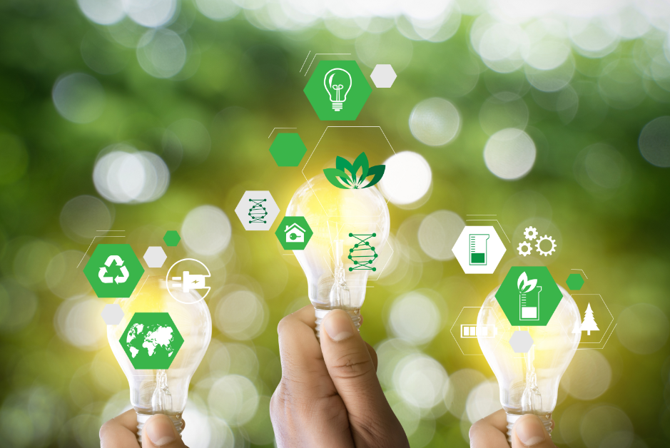 hands holding lightbulbs on an unfocused green-and-white background, overlaid with icons suggesting sustainable technology