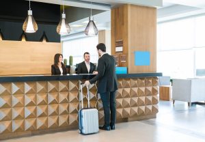 Happy Hotel Clerks Are Welcoming Professional At Counter