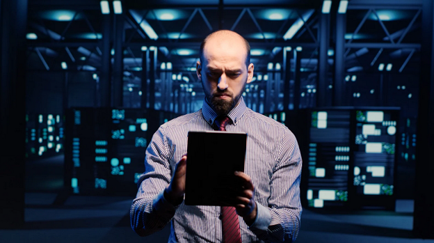 A member of the managed network services/MSP team using a tablet in a server room