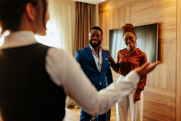 a staff member providing great service to happy guests at a luxury hotel