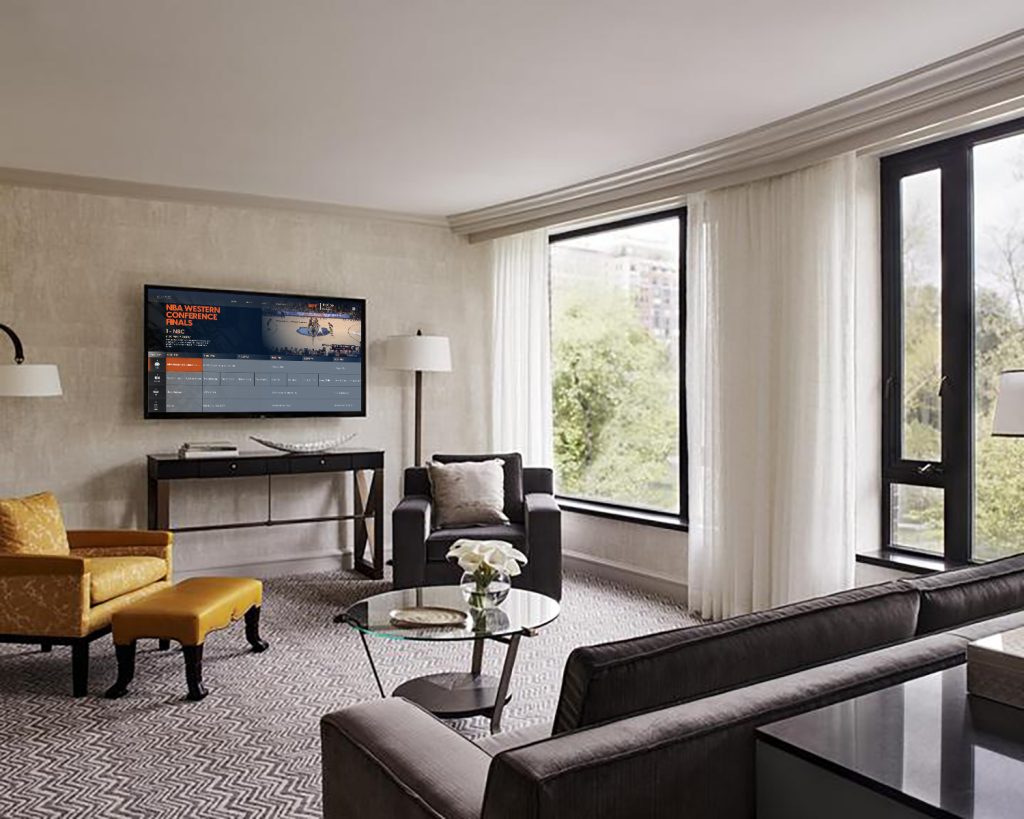 hotel room seating area with TV showing The HUB programming guide