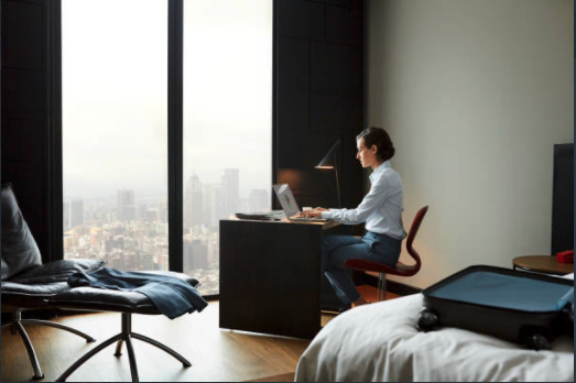 business traveler working at hotel room desk