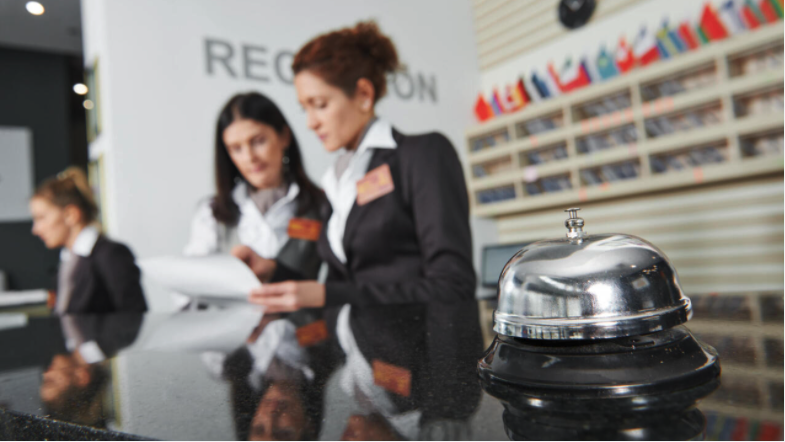 Hotel front desk customer service agents assist customers. 