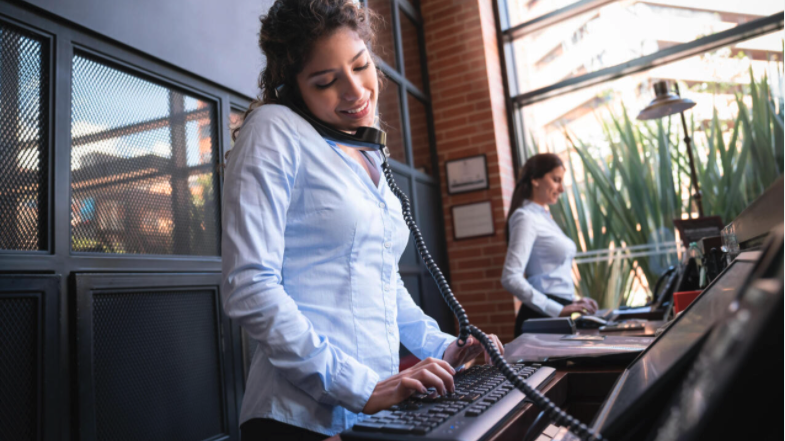 front desk staff using phones and computers