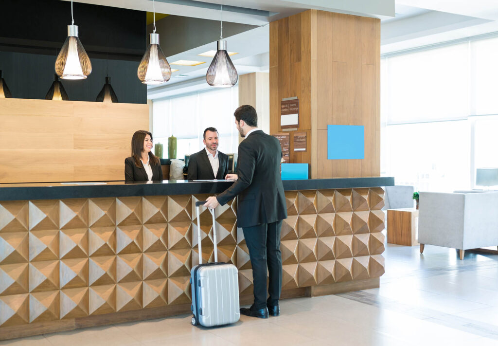 Happy Hotel Clerks Are Welcoming Professional At Counter
