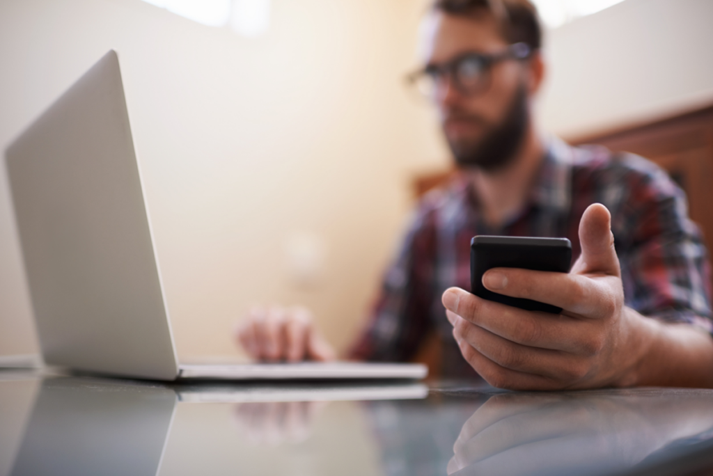 man using multiple devices in BYOD setting