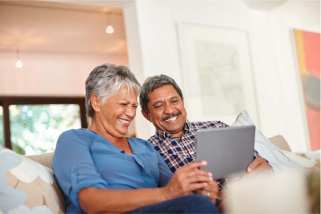 2 seniors looking at a tablet