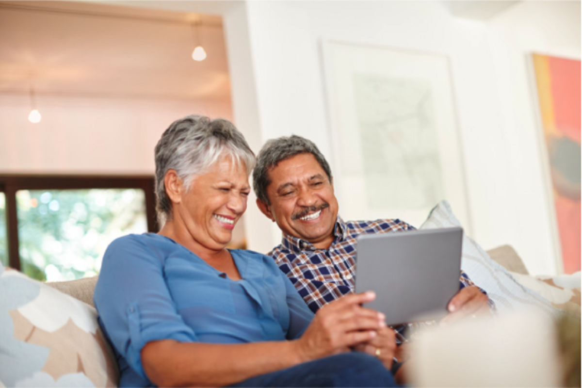 2 seniors looking at a tablet