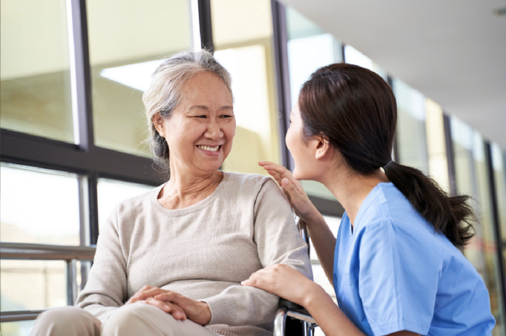 staff speaking with senior living resident