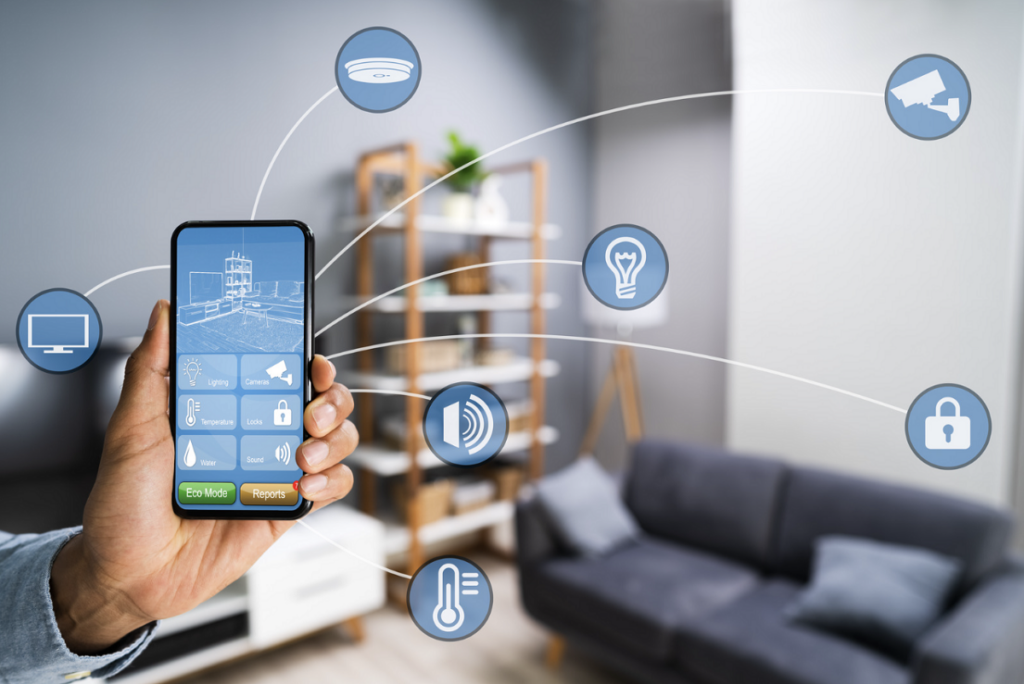 living room with icons representing smart home functions, and a hand holding a smart phone to control them