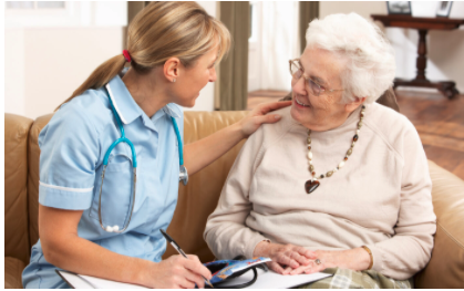 staff sitting and talking with senior living resident