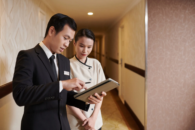 hotel staff looking at a tablet, possibly using it to manage their property technology
