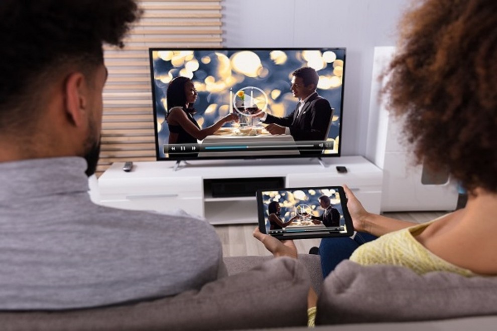 guests in a hotel room streaming/casting from their device to the in-room TV